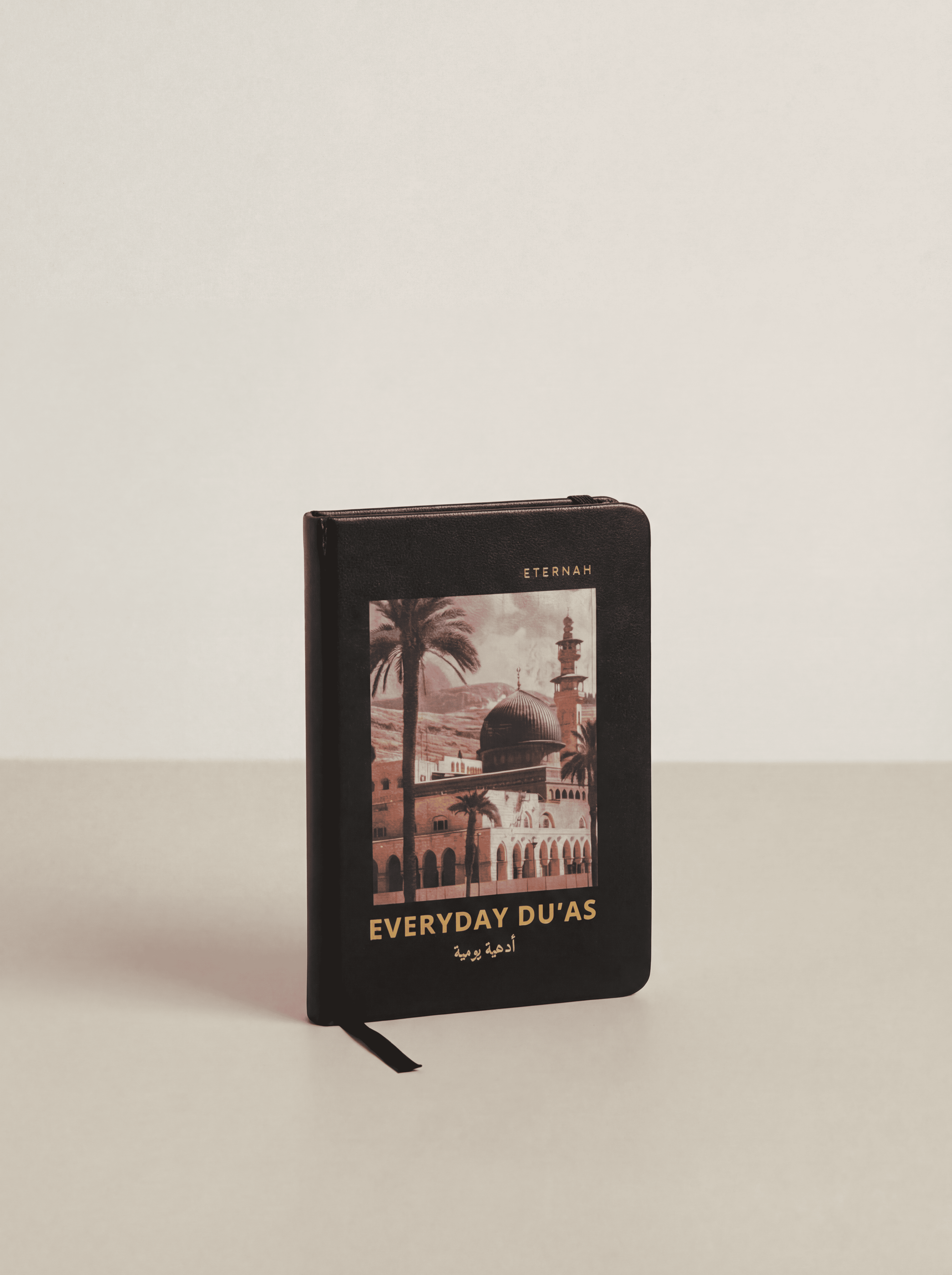 Black book titled 'Everyday Du'as' with a scenic cover on a light gray background